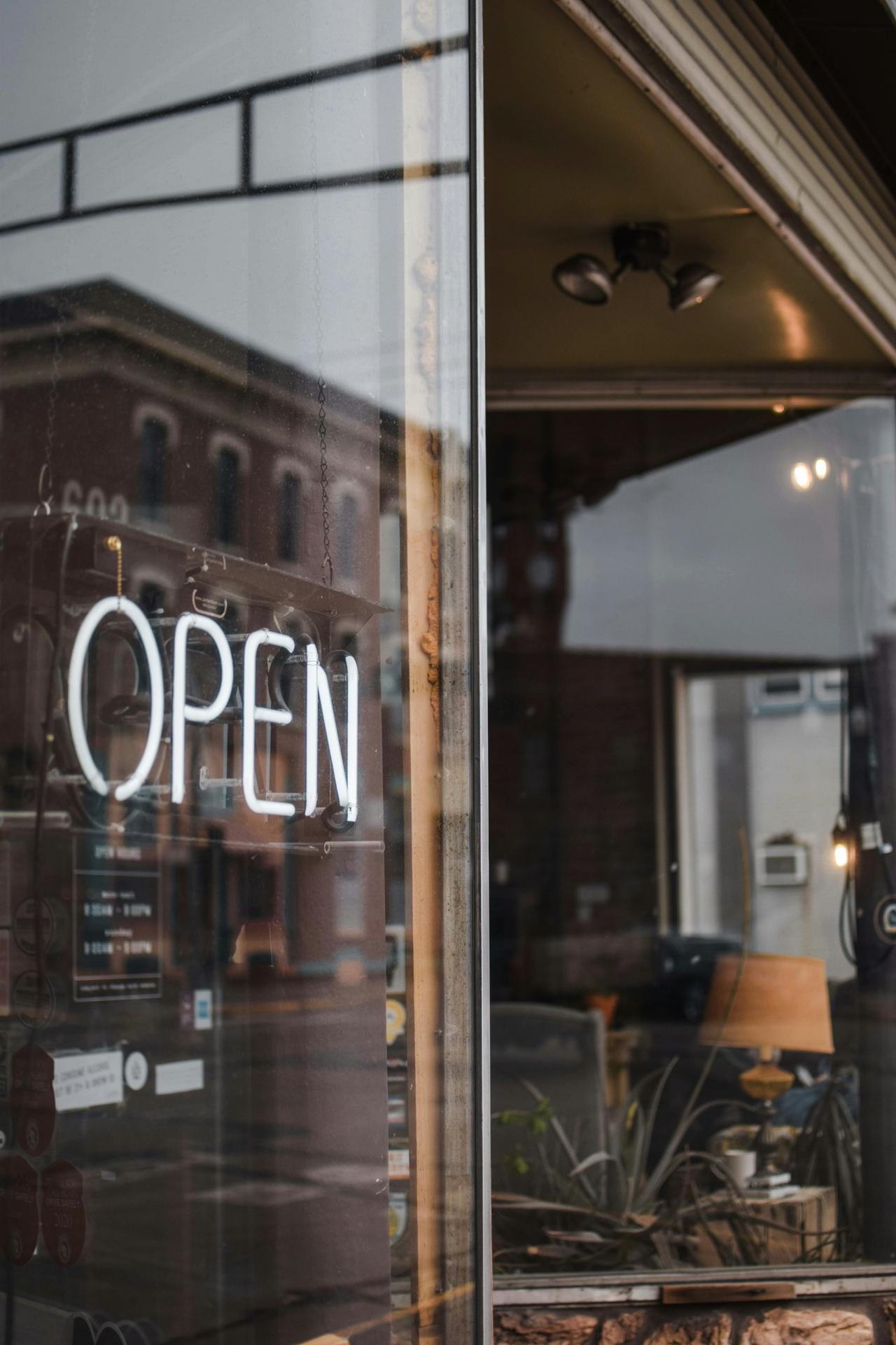 An open sign glowing in a shop window